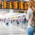 woman walking in the airport with a cellphone