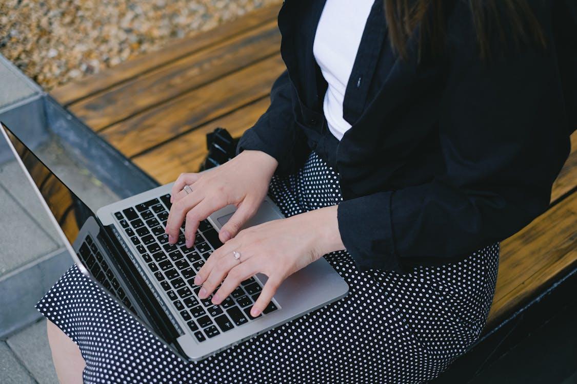 Free Woman Typing on Laptop Stock Photo