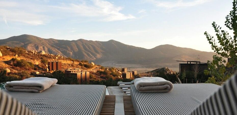 sunloungers fronting buildings near mountain