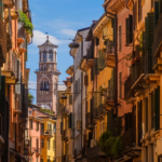 Via Mazzini in Verona, the historic street where the vision of the Statue of Peace was born, bustling with shops and cultural heritage, reflecting the city’s role as a birthplace of hope, unity, and artistic expression