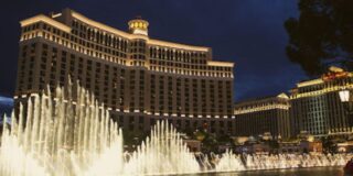 Night view of the Bellagio Las Vegas with its illuminated fountain show in front.